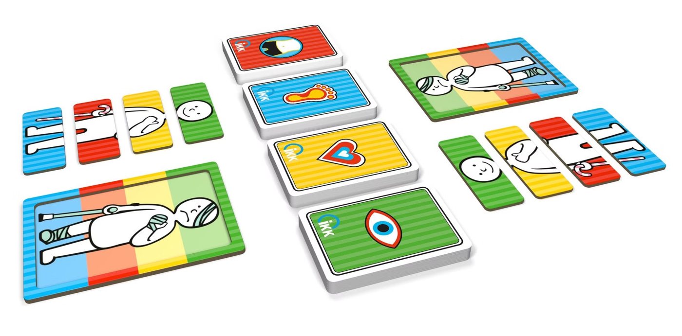 The game laid out: colourful question cards with symbols for eyes, heart and feet, and boards with a sugar figure to complete